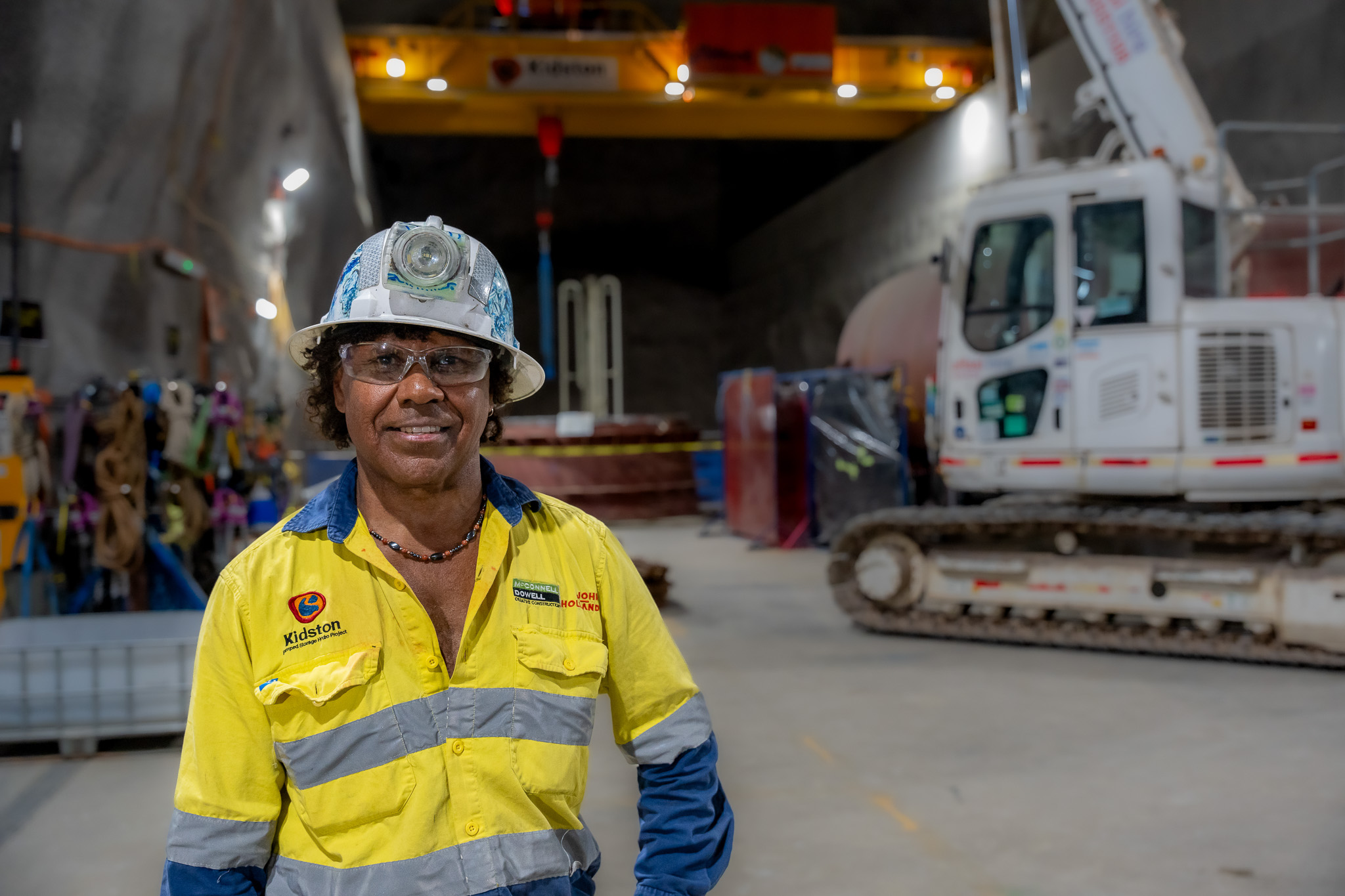 Ross Rosas in the underground cavern wearing high visibility safety uniform at the Genex Kidston Hydro Pumped Storage Project