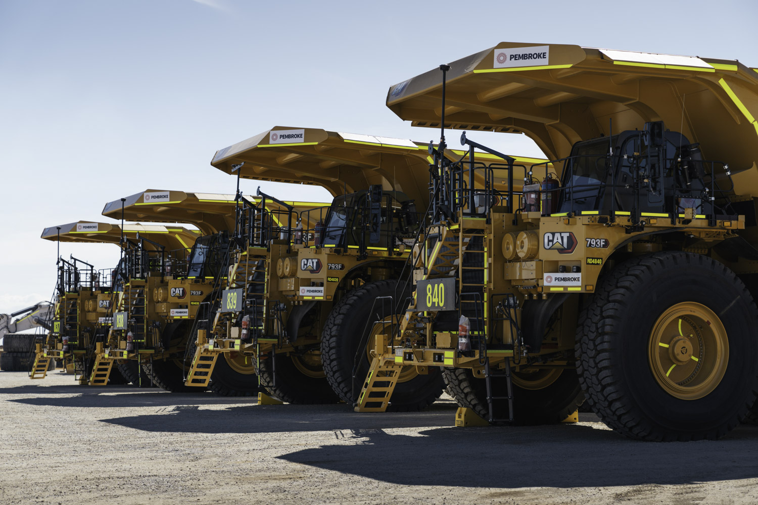 Pembroke Olive Downs Steelmaking Coal Project Four Large Orange Mining Trucks