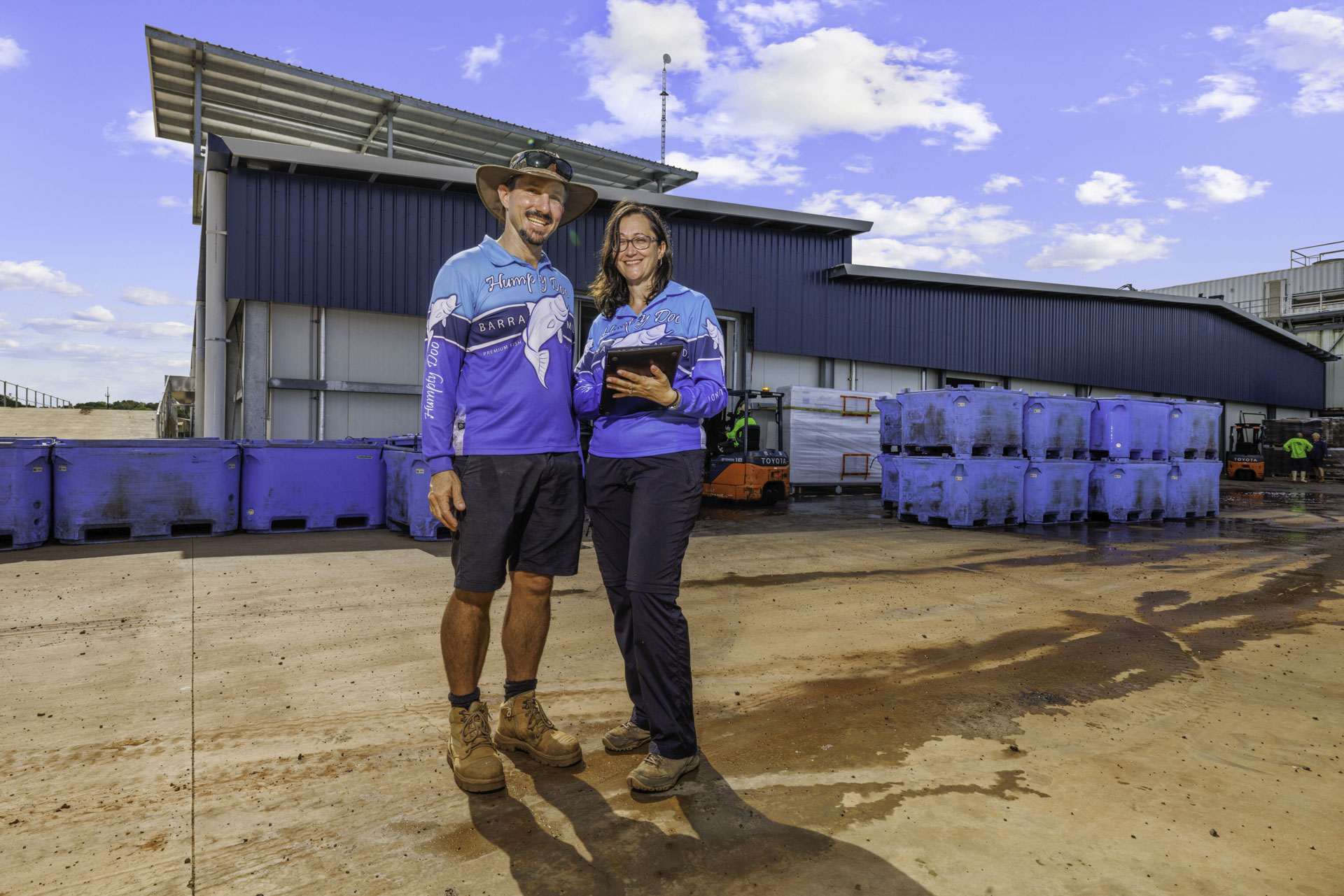 Humpty Doo Barramundi Wide Angle View Of Workers One Holding A Clipboard And The Warehouse In The Background