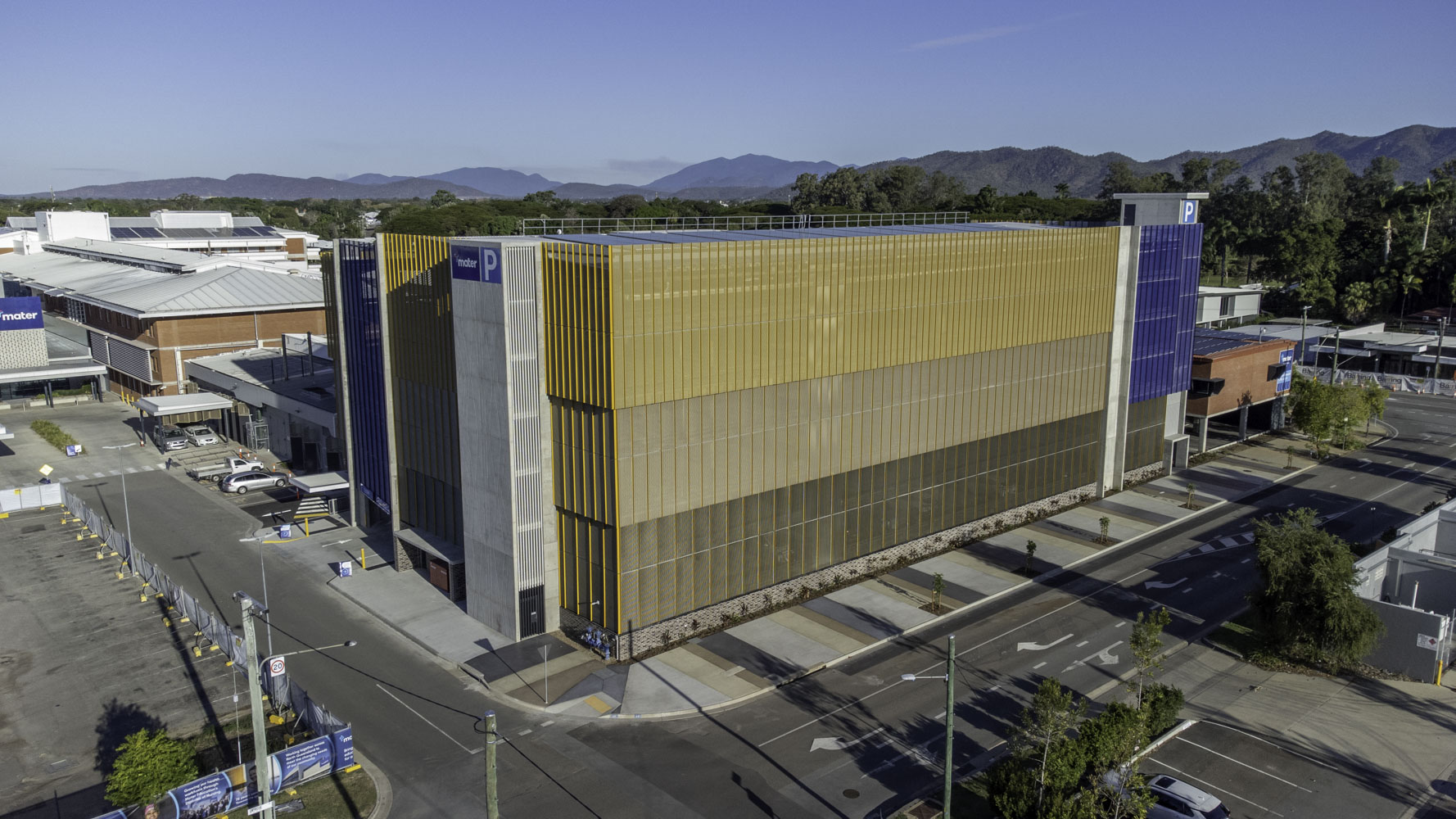 Mater Health Multi Storey Carpark Townsville Aerial View Yello Wand Blue Exterior Mountains In Background