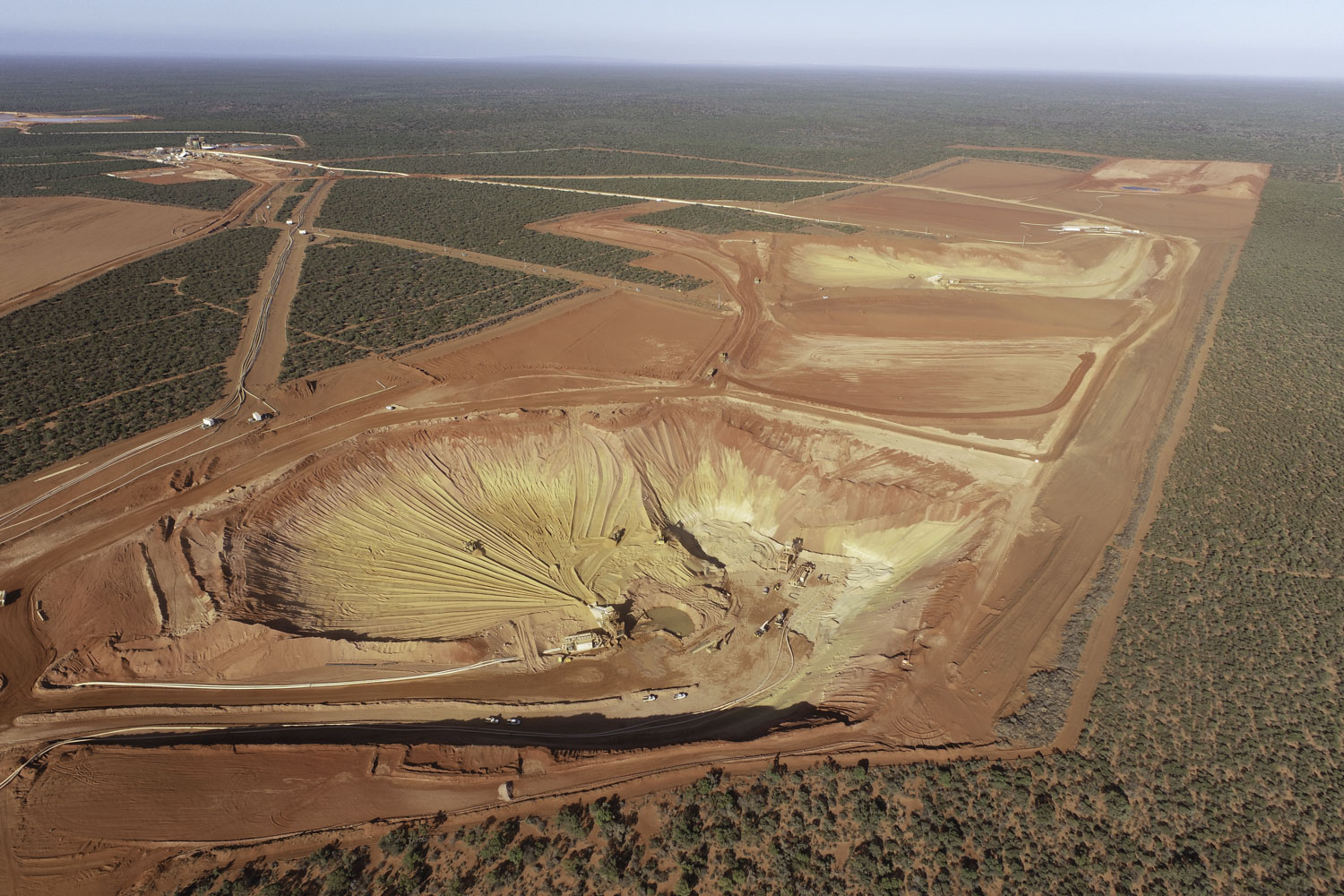 Strandline Resources Coburn Heavy Mineral Sands Project Mine Pit With Processing Plant In The Distance