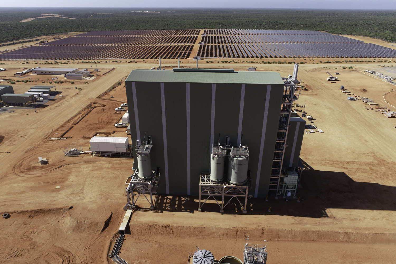 Strandline Resources Coburn Heavy Mineral Sands Project Aerial View Of Large Green Building With Tanks On Outside And Large Solar Panel Farm In Background