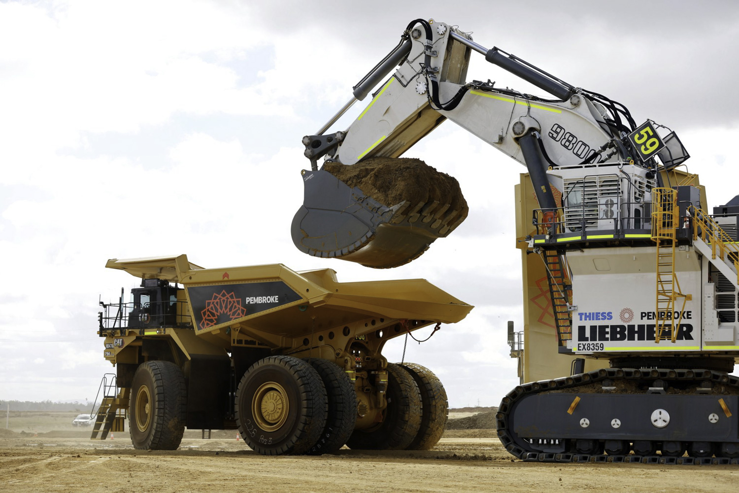 Pembroke Olive Downs Steelmaking Coal Project Large Digger Loading Orange Mining Truck Full Of Dirt