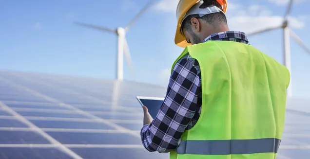 Man Working At Solar Power Station With Digital