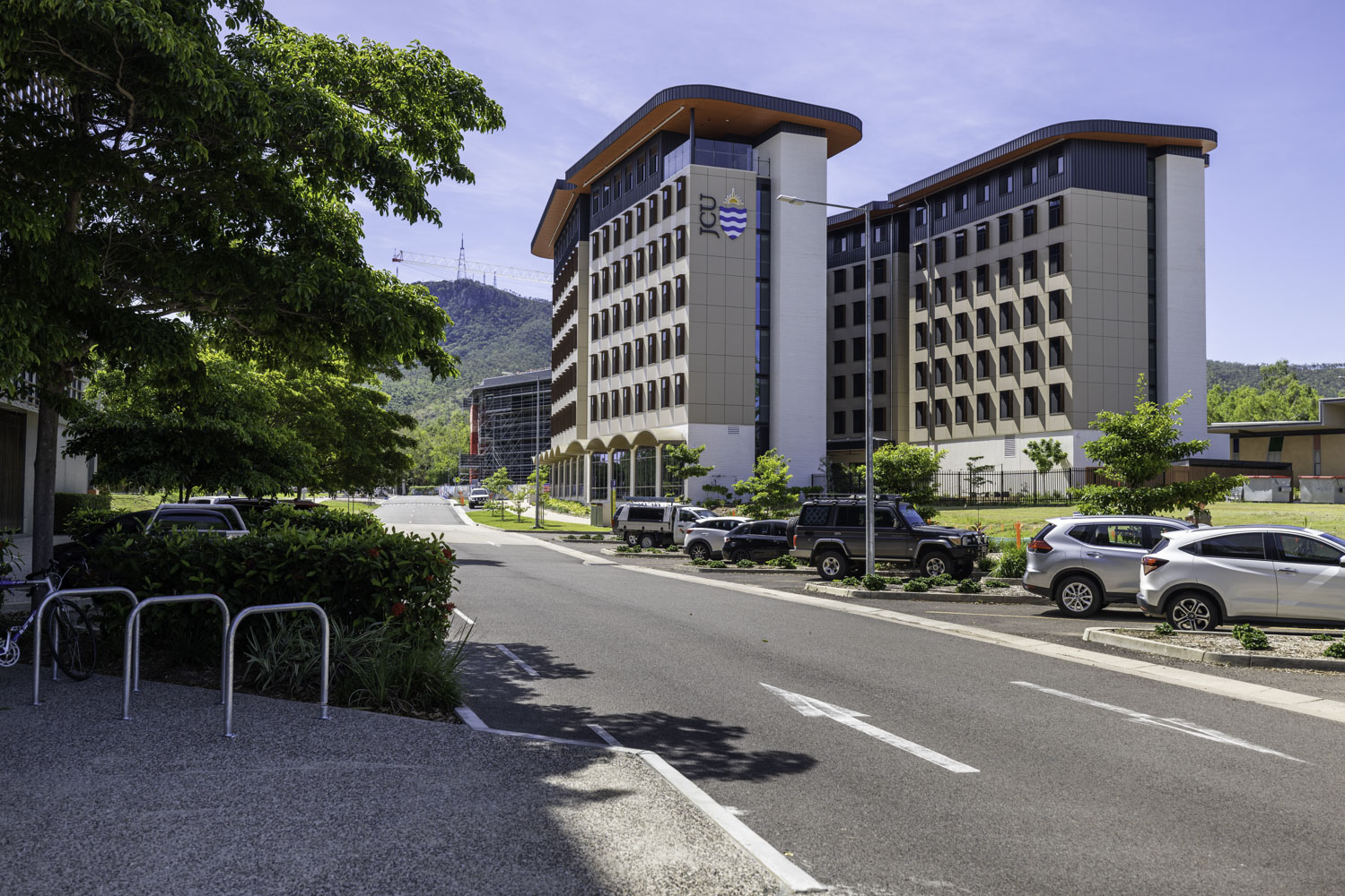 HERO JCU Student Accommodation Wide View From Street With Road Cars And Trees And Mountains In Background