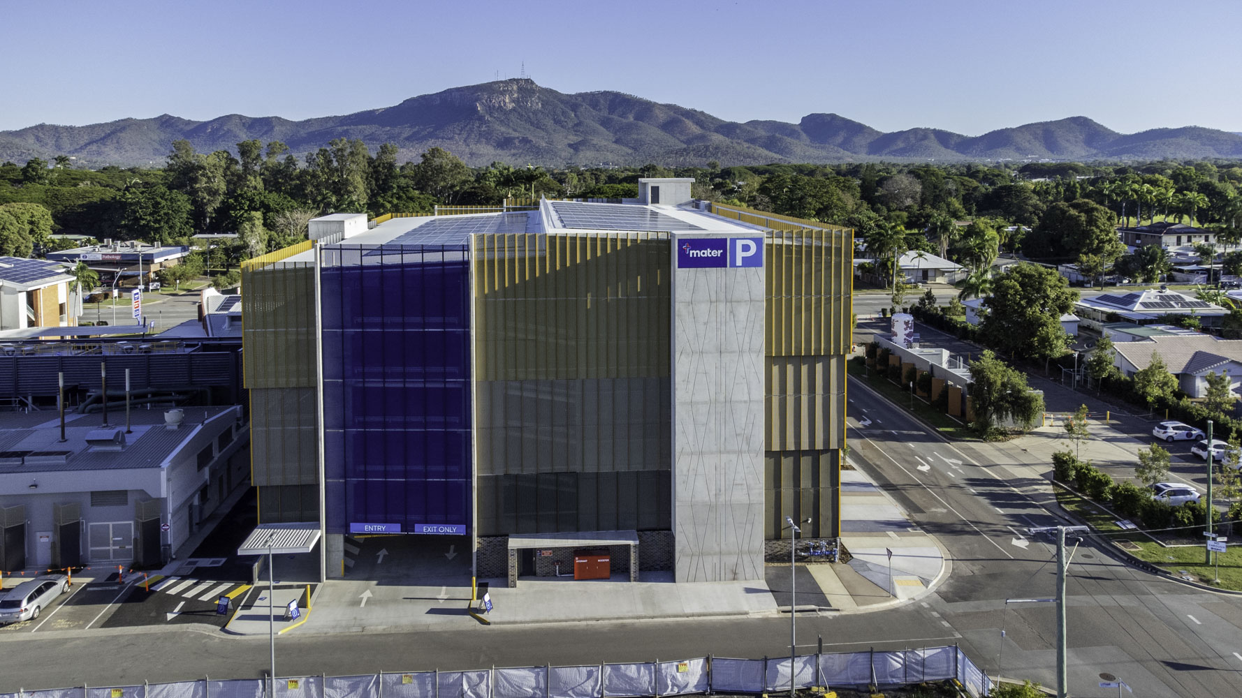 Mater Health Multi Storey Carpark Townsville Aerial View Of Left Side Yellow And Blue Exterior Mater Logo Parking Sign And Mount Stuart In The Background