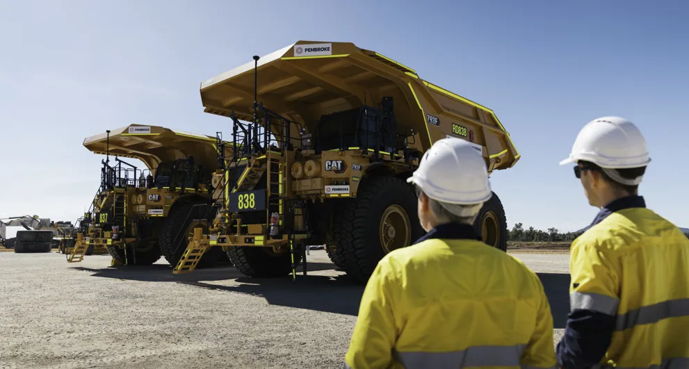 Pembroke Olive Downs Steelmaking Coal Project Two Workers Inspecting Large Orange Mining Truck