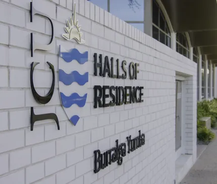 JCU Halls Of Residence Front Entrance Signage Jcu Logo White Brick Wall Burralga Yumba on Halls of Residence (Burralga Yumba)